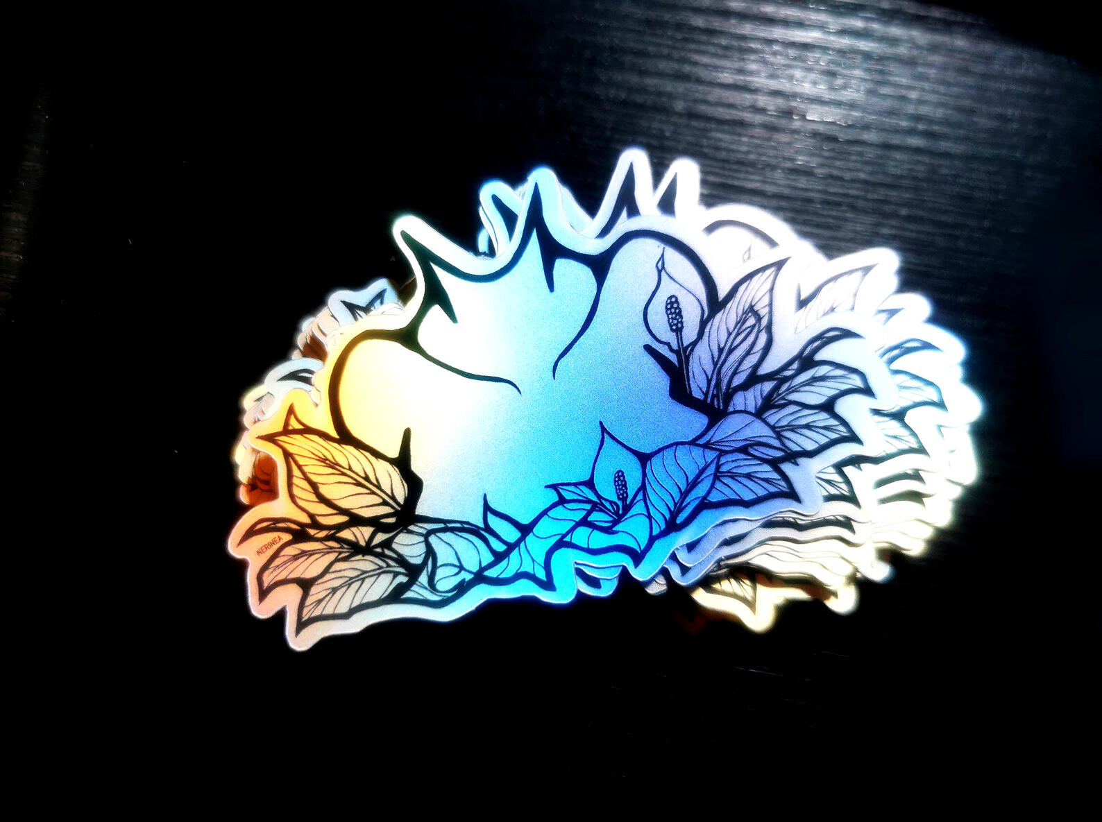 Original design. Black lineart printed on matte holographic vinyl material.